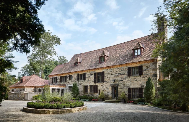 Stone manor house with cedar shake roof