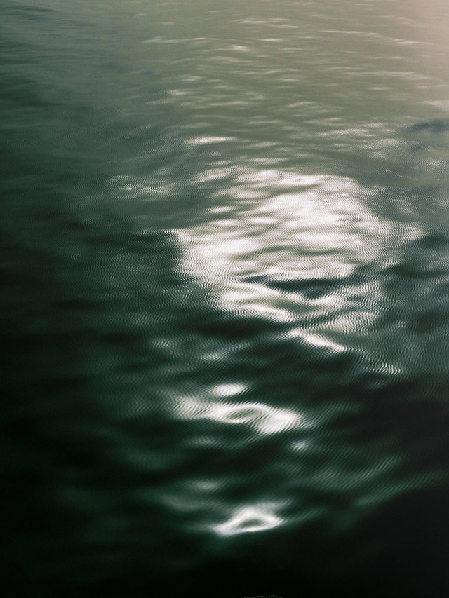 Sunlight reflecting on rippling dark water